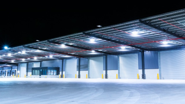 exterior-of-a-large-industrial-warehouse-in-a-commercial-zone-picture-id1025369872 Change Your Clocks and Upgrade Your Lighting